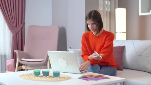 Young Woman Working on Laptop in Living Room