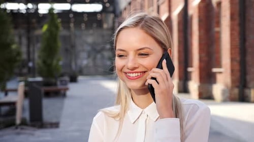 Attractive Woman Talking on a Cell Phone Outdoors