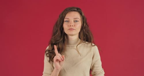 Studio Portrait of Disgruntled Angry Young Adult Woman Caucasian Millennial Girl with Long Hair