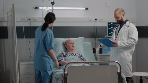Doctor and Nurse Attending to Patient in Hospital