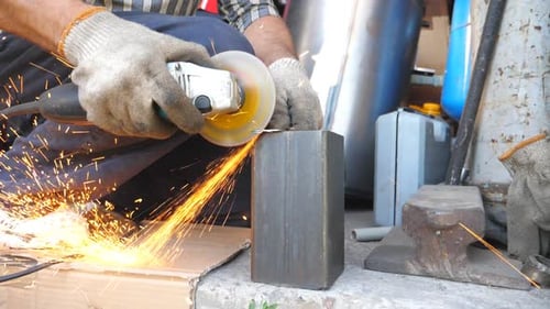Close Up on Metal Processing with Circular Saw and Bright Sparks Flying Around