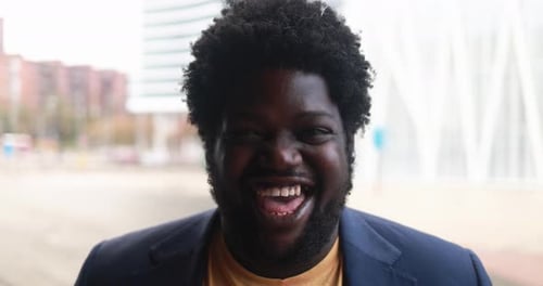 Happy african curvy man smiling on camera outdoor