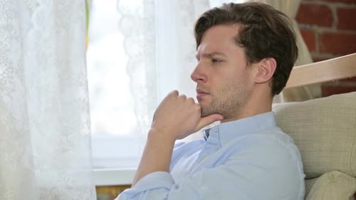 Portrait of Young Man Thinking About Creative Idea