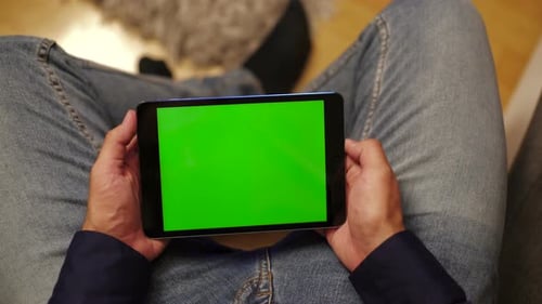 Person Holding Tablet with Green Screen Indoors