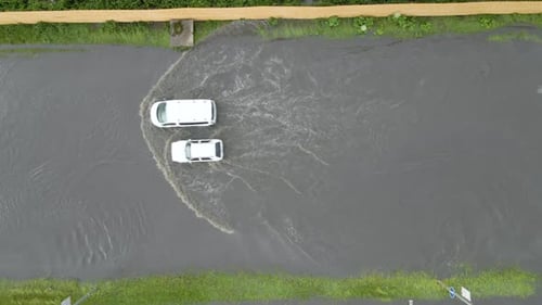 Aerial View of City Traffic with Cars Driving on Flooded Street After Heavy Rain