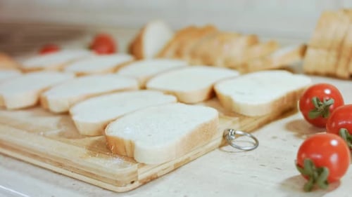Sliced Bread and Tomatoes on Cutting Board