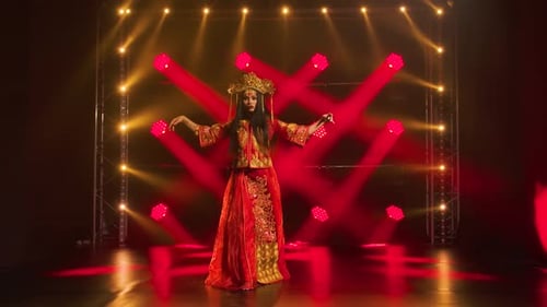 Graceful Woman Dancing on Stage with Dramatic Lighting