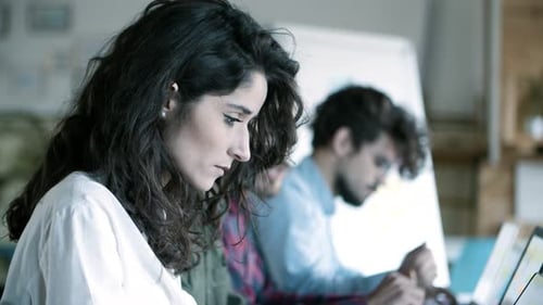 Young Adults Working Together in a Bright Office