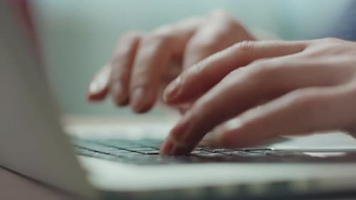 Hands Typing on a Laptop Keyboard, Close Up
