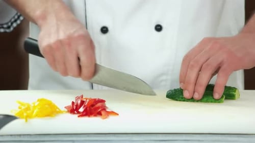 Close Up Chef Slicing Cucumber With Knife