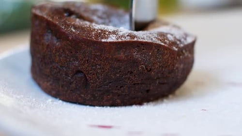 Women eating chocolate cake in a summer cafe. Liquid chocolate flows smoothly out of the cake
