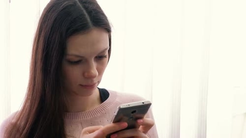 Woman Using Mobile Phone Indoors