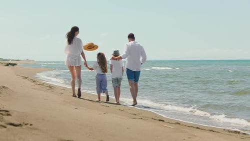 Family with children walking along coast