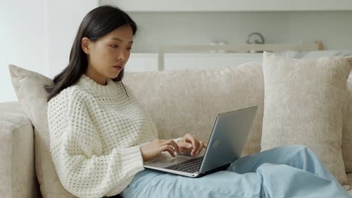 Woman Working on Laptop Computer Indoors at Home