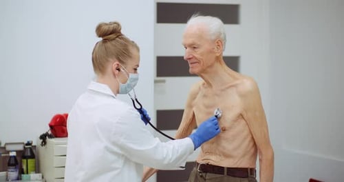 Female Doctor Examine Elderly Man with Stethoscope