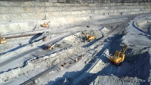Upper View Open Asbestos Deposit with Excavators and Trucks