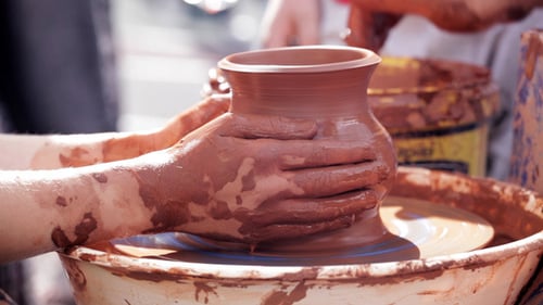 Hands Creating Clay Pottery on a Wheel