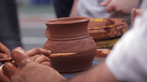 Potter Shaping Clay Vase on Spinning Wheel