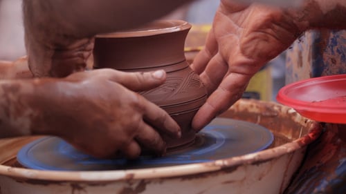 Hands Forming Clay Pot on Pottery Wheel