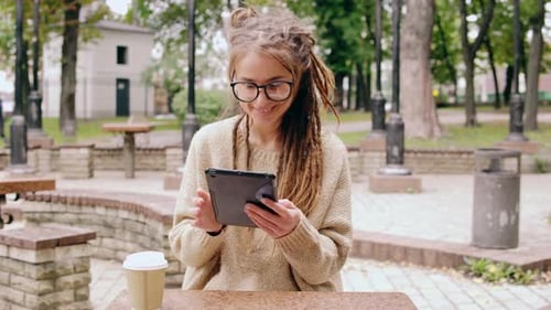 Smiling Hipster Girl Resting in Park