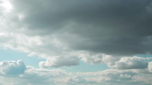 Cloudy Blue Sky With Fluffy Clouds