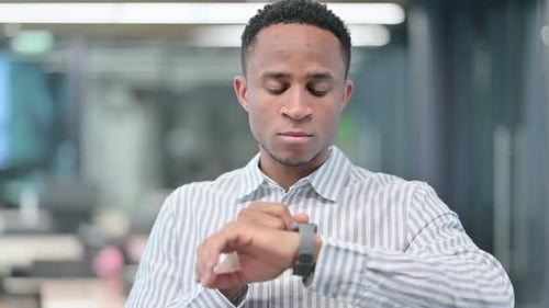 Young Adult Using Smart Watch in Modern Workplace