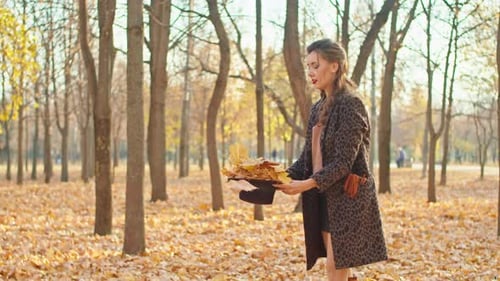 Happy Playful Woman in Coat Hat and Scarf in Autumn Park