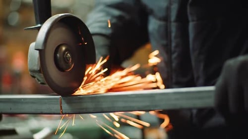 Angle Grinder Cutting Metal at Workshop