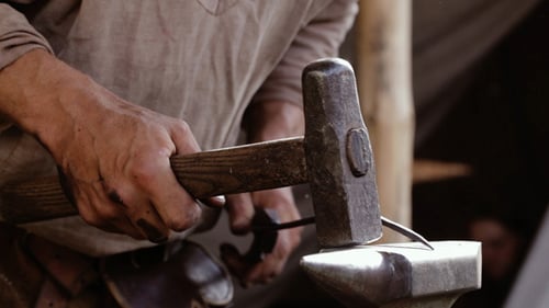 Blacksmith Working with Hammer on Anvil