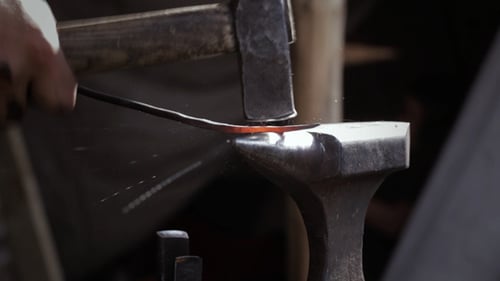 Blacksmith Shaping Hot Metal on Anvil Close Up