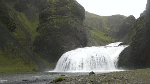 Iceland. Famous Waterfall In Iceland Water Flowing Through High Cliffs Inspiration Epic Scale Nature