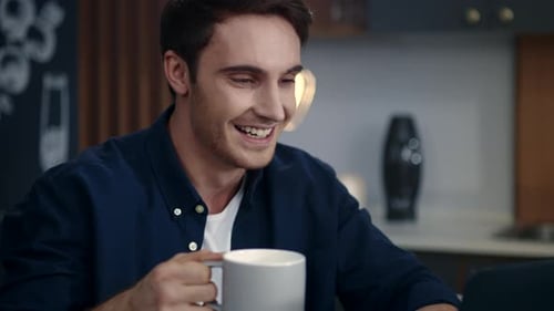 Portrait of Smiling Businessman Making Video Call on Computer at Home Office