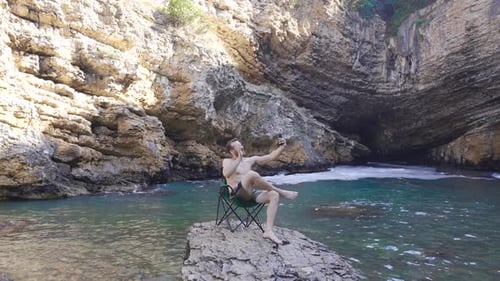 Young man talking on the phone in the canyon.