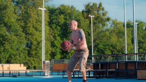 Man Shooting Basketball on Outdoor Court
