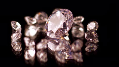 Sparkling Cut Diamonds on Black Reflective Surface
