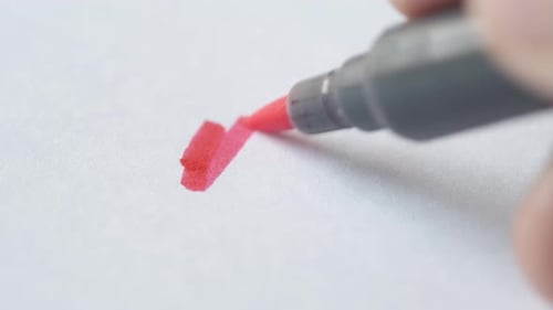 Red Marker Drawing Abstract Shape on Paper