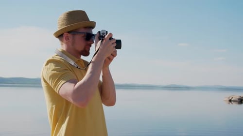 Young Man Taking Picture of Nature