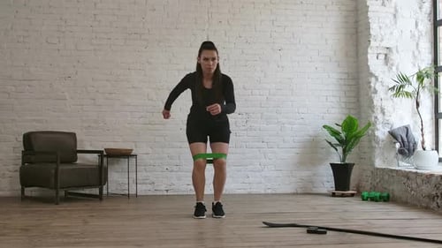 Woman Doing Leg Abductions with Resistance Band