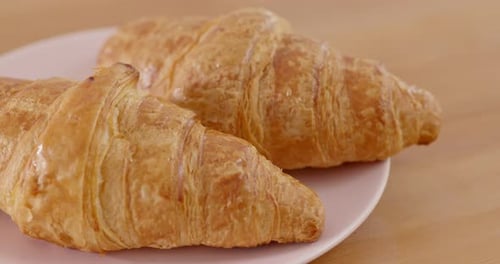 Two Golden Croissants on a Plate