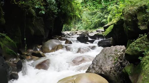 Wir fliegen über einen wunderschönen Fluss mit großen Felsbrocken, die aus der schnellen Strömung herausragen