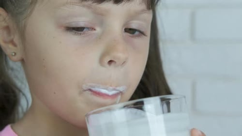 The Child Is Drinking Milk.