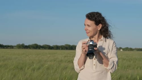 Female with a camera in the field.
