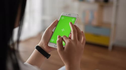 Closeup of hand woman using smartphone with green screen