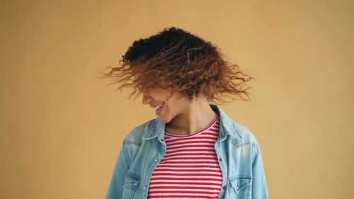 Happy Woman Shaking Curly Hair