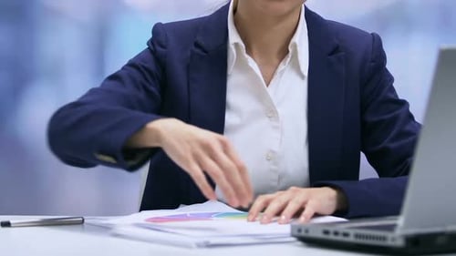 Adult Woman Working with Papers at Office Desk