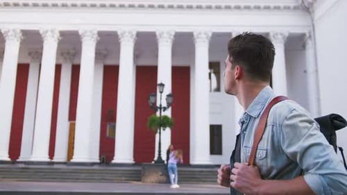 Attractive Young Handsome Man Tourist with Backpack Walking in City Center
