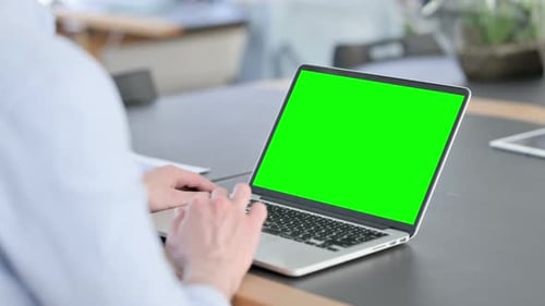 Laptop with Green Screen, Person Typing