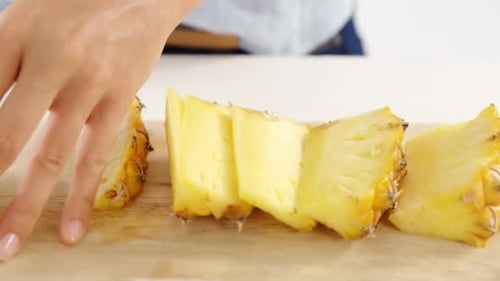 Preparing Pineapple on Wooden Cutting Board