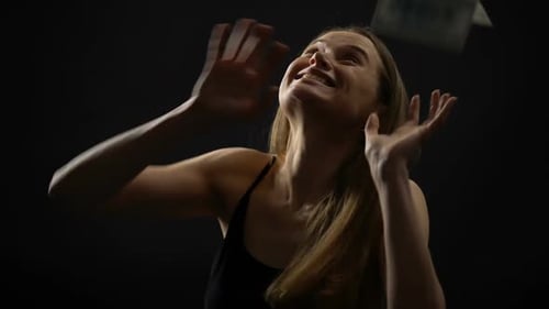 Woman Throwing Money in the Air in Celebration