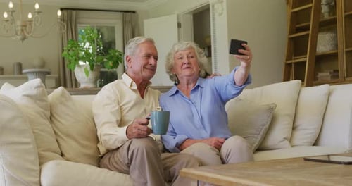Cheerful Senior Couple Relaxing Taking Selfie